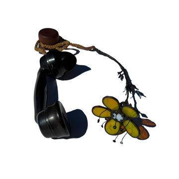 Old-style telephone receiver with flower decoration.