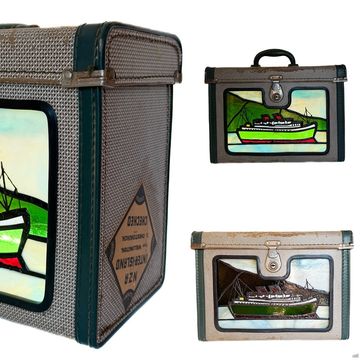 Vintage luggage with boat design and textured sides.