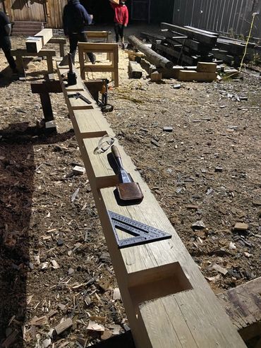 Woodworking tools and work in progress outdoors.