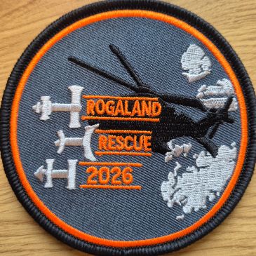 Brodert Rogaland Rescue 2026 merke med helikoptere og orange skrift.