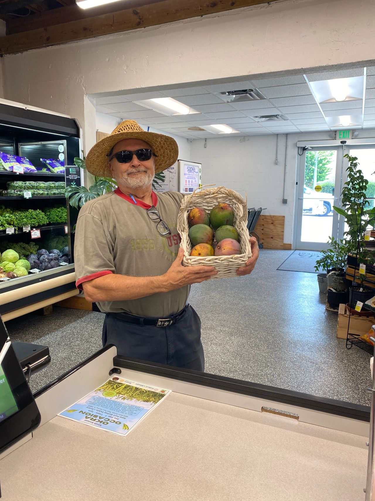 Volunteer delivering fresh local mangos to Wright’s Natural Market in New Port Richey.  Wright's Natural Market is a partner of NPR Farmnet