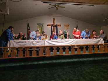 People reenacting The Last Supper in a church setting.