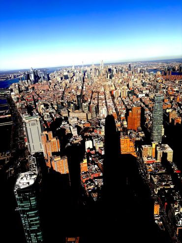 Aerial view of New York City skyline with shadows.