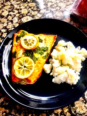 Plate with grilled fish and mashed potatoes.