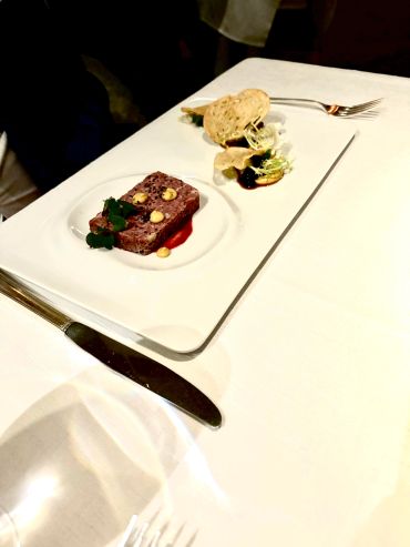 Elegant plated gourmet dish with garnish.