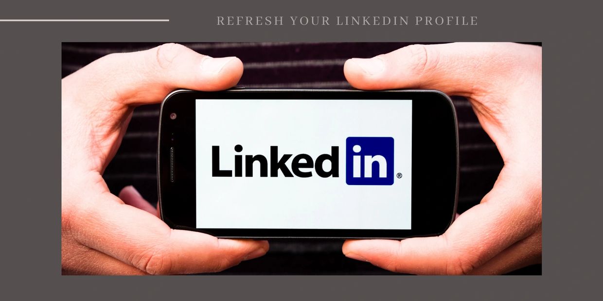 A person holds a smartphone displaying the LinkedIn logo