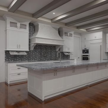 Modern white kitchen with large island and gray countertop.