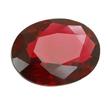 A polished red gemstone with an oval cut.