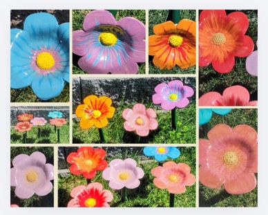 Colorful decorative flower sculptures in a garden setting.