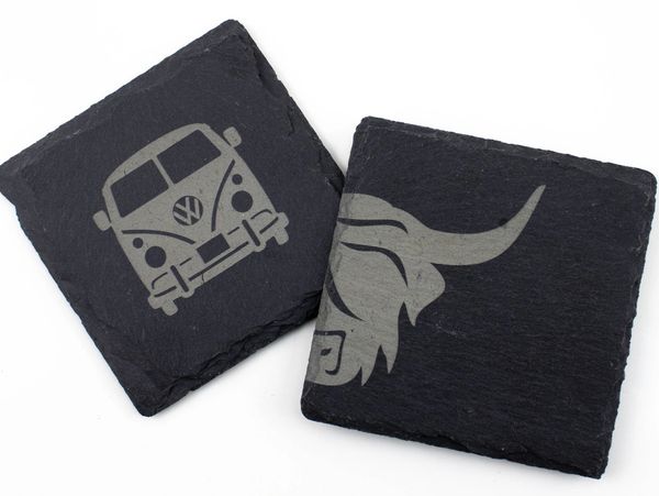 Two slate coasters featuring a highland cow and a campervan