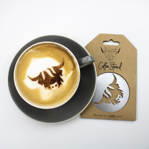 A photo of a cappuccino with a Highland Cow chocolate stencil design, next to the coffee stencil.