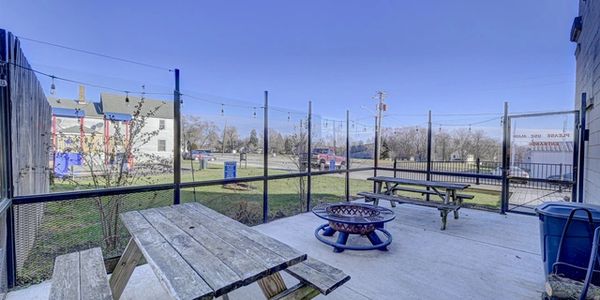 Our patio seating including 2 picnic tables and a fireplace. 