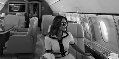 Elegant professional woman on a private jet aircraft.