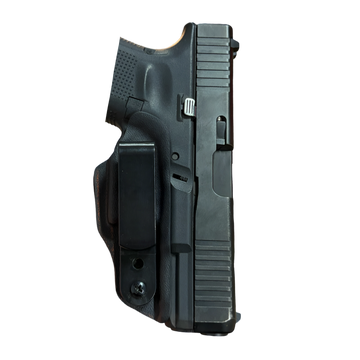 Close-up of a black handgun grip and slide.