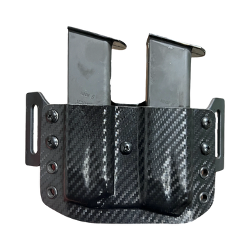 Carbon fiber dual magazine pouch with two metal magazines.