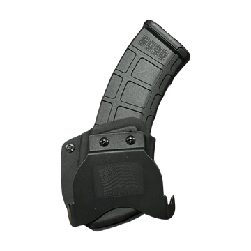 Black firearm magazine partially inserted in a holster with an American flag emblem.