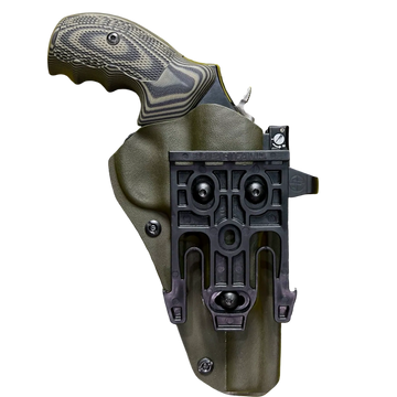 Revolver handle with textured grip in a green holster and mounting clip.