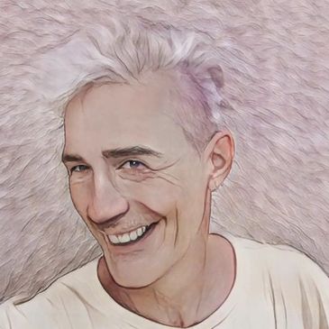 Portrait of a smiling man with light hair against a textured background.
