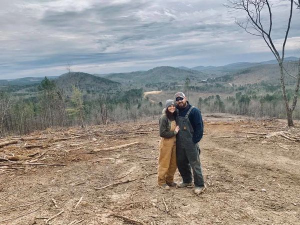 Trail riding couple with scenic mountain background.