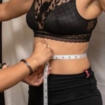 Measuring waist circumference with a tape measure.