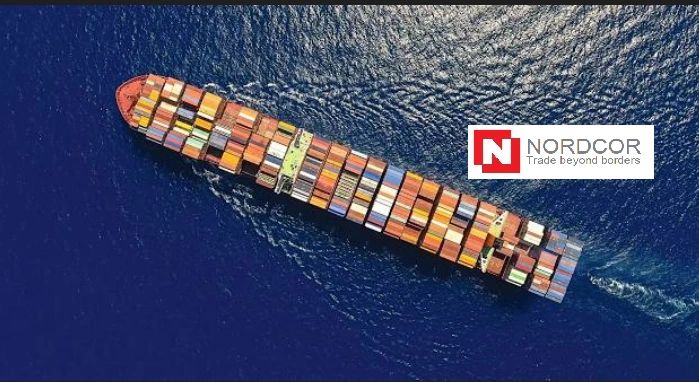 Aerial view of a container ship sailing in deep blue waters with Nordcor logo.
