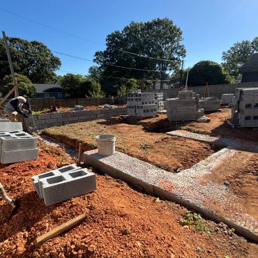 Construction site with concrete blocks and foundation work.