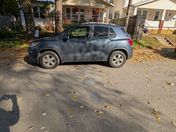 Gray SUV parked on a residential street during daytime.