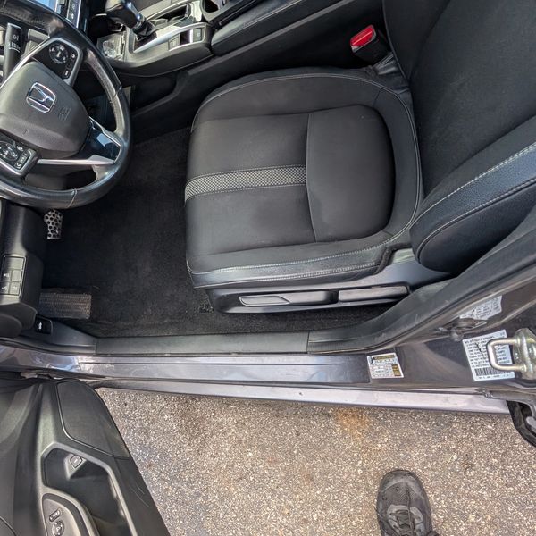 Interior of a Honda car focusing on the driver's seat area.