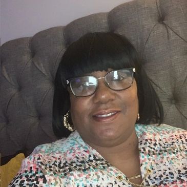 A woman sitting on a sofa and looking ahead