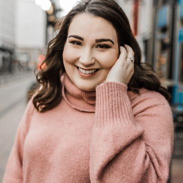 Therapist, licensed clinical social worker in a pink sweater with brown hair, smiling