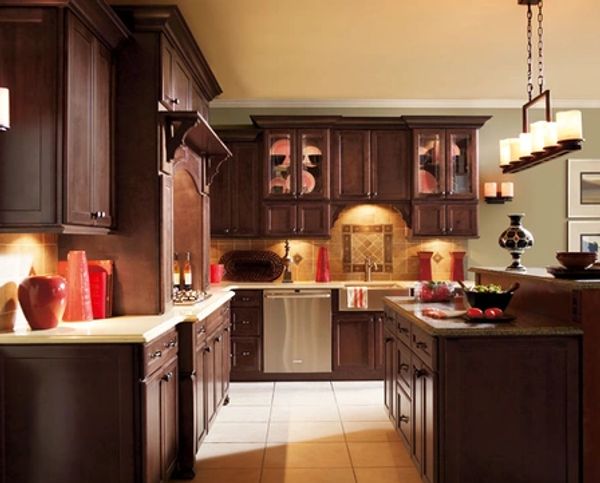 Traditional kitchen with dark wood cabinets and warm lighting.