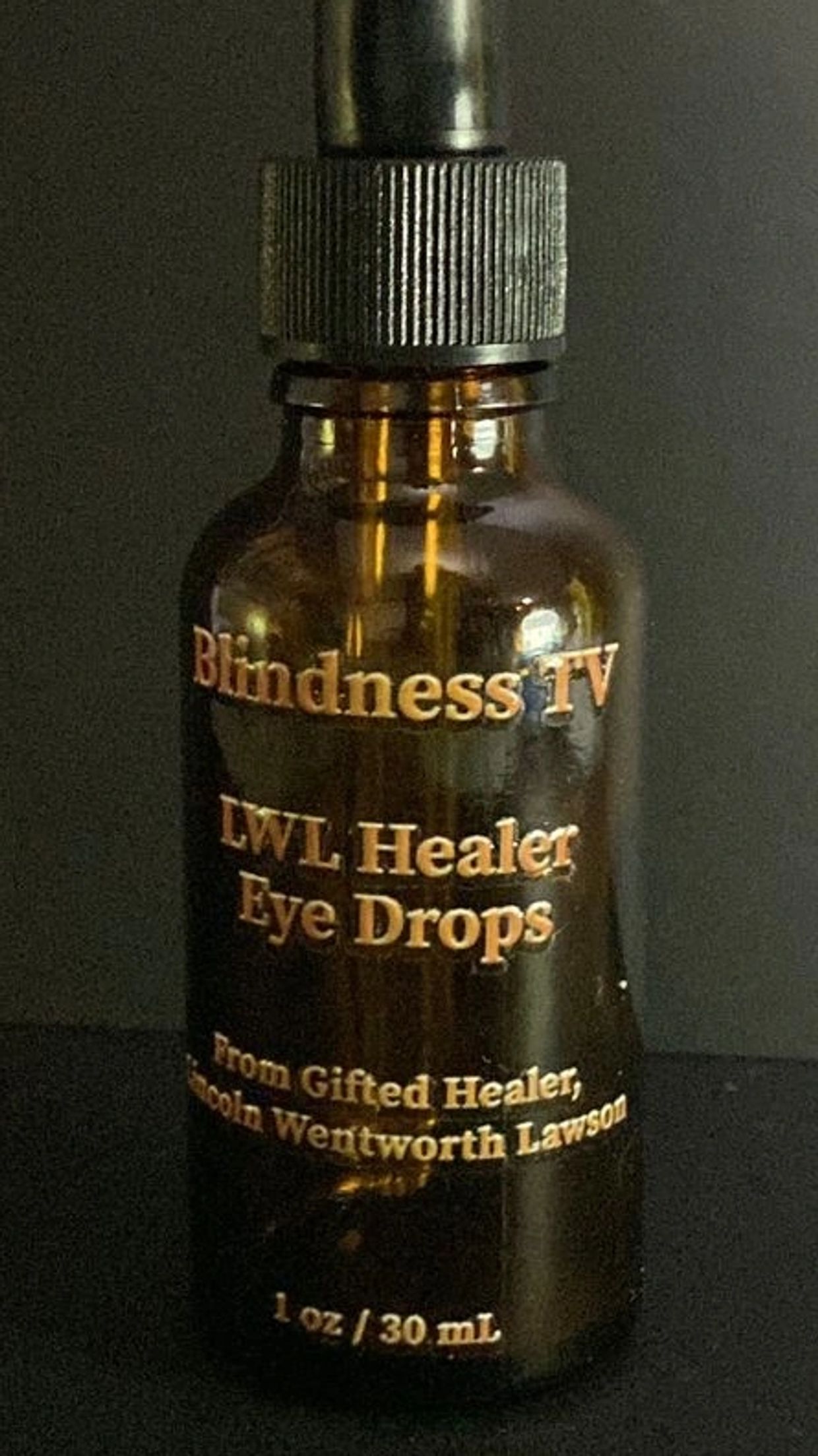 Dark glass bottle labeled 'Blindness TV LWL Healer Eye Drops'.