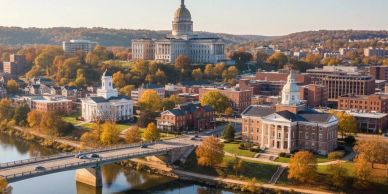 Aerial view of a city with a river and buildings in autumn.