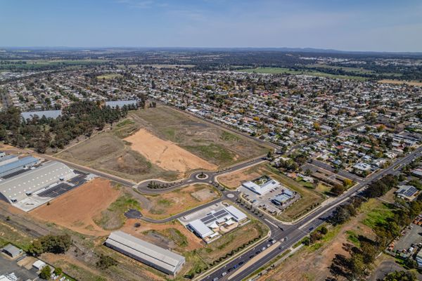 Aerial view of a suburban area with residential houses and commercial buildings.