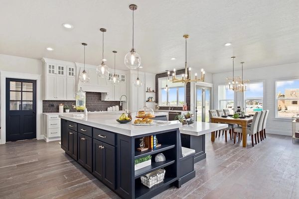 Updated kitchen with newly installed electrical pendant lights, chandeliers, and recessed cans. 