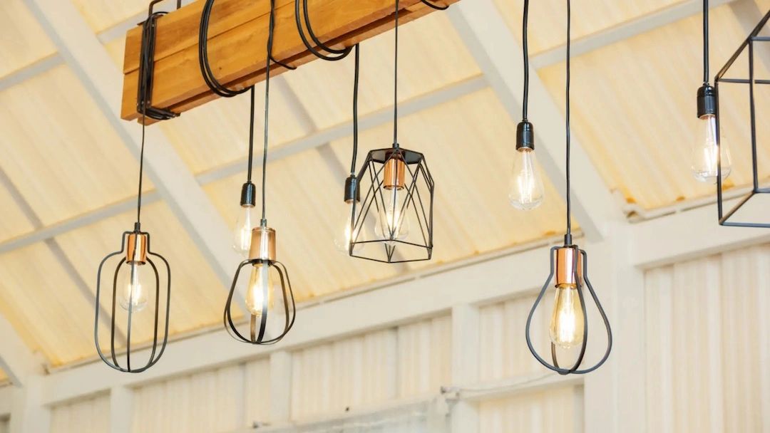 Full ceiling open space lighting installation showcasing light fixtures from wooden beam. 