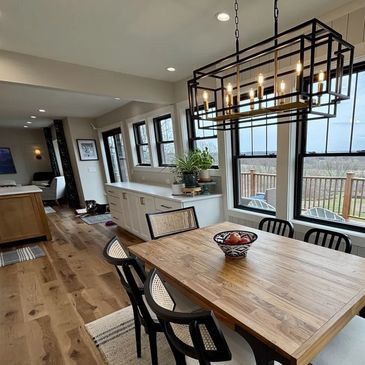 Dining room lighting installation with chandelier and natural light in Jefferson County WI