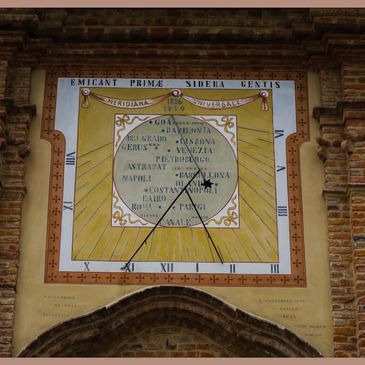 A church dial in Canale, Italy. In addition to local time this shows when it is noon in other cities