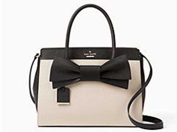Elegant black and beige handbag with a large bow detail.