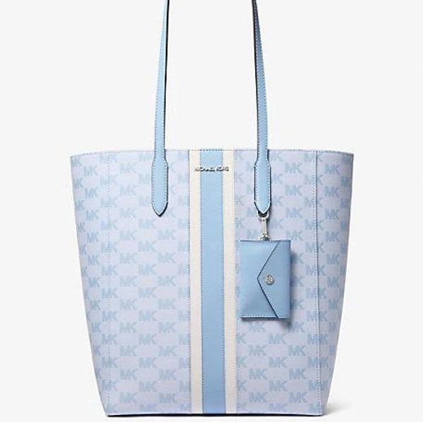 Light blue Michael Kors tote bag with logo pattern and attached pouch.