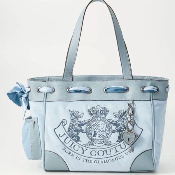 Light blue Juicy Couture tote bag with crest and heart lock charm.