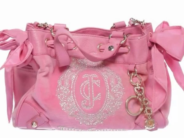 Pink handbag with rhinestone embellishments and bow details.