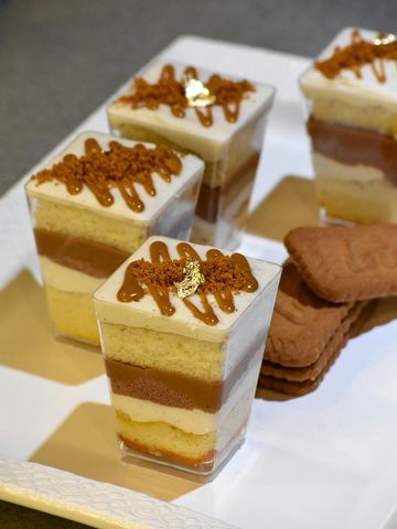 A plate of Biscoff cookie cake jars, with layers of frosting, cake and cookie butter
