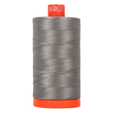 A spool of gray Aurifil sewing thread with an orange top and base.