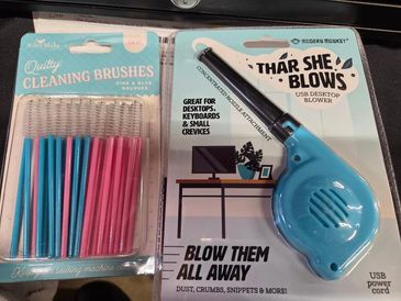 Cleaning brushes and a USB desktop blower for dust removal.