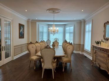 The dining room has been upgraded with a new floor, pot lights, and freshly painted walls