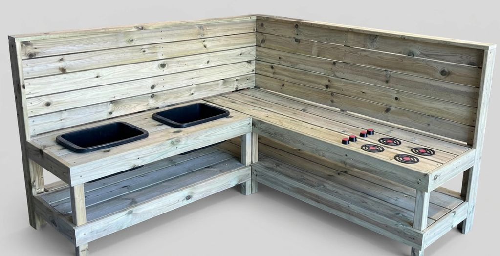 Wooden play kitchen with sink basins and stove burners.
