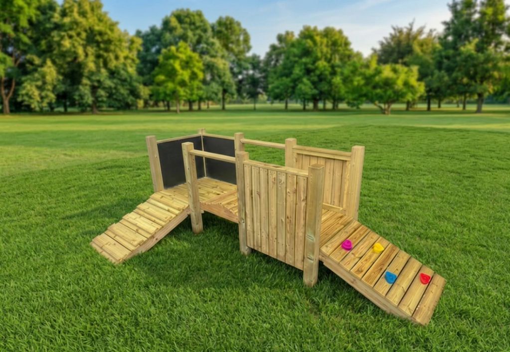 Wooden play structure with ramps on a grassy field.