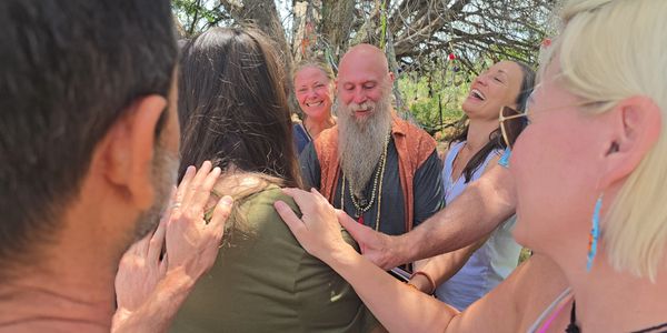A group sharing a joyful moment outdoors.