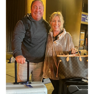 Couple holding suitcase and bags